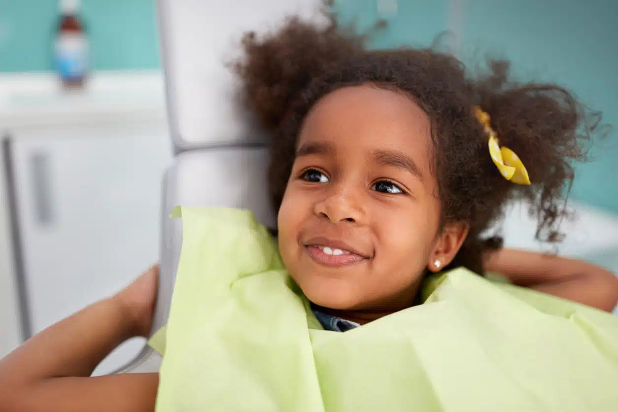 a close up of a young child smiling at the camera